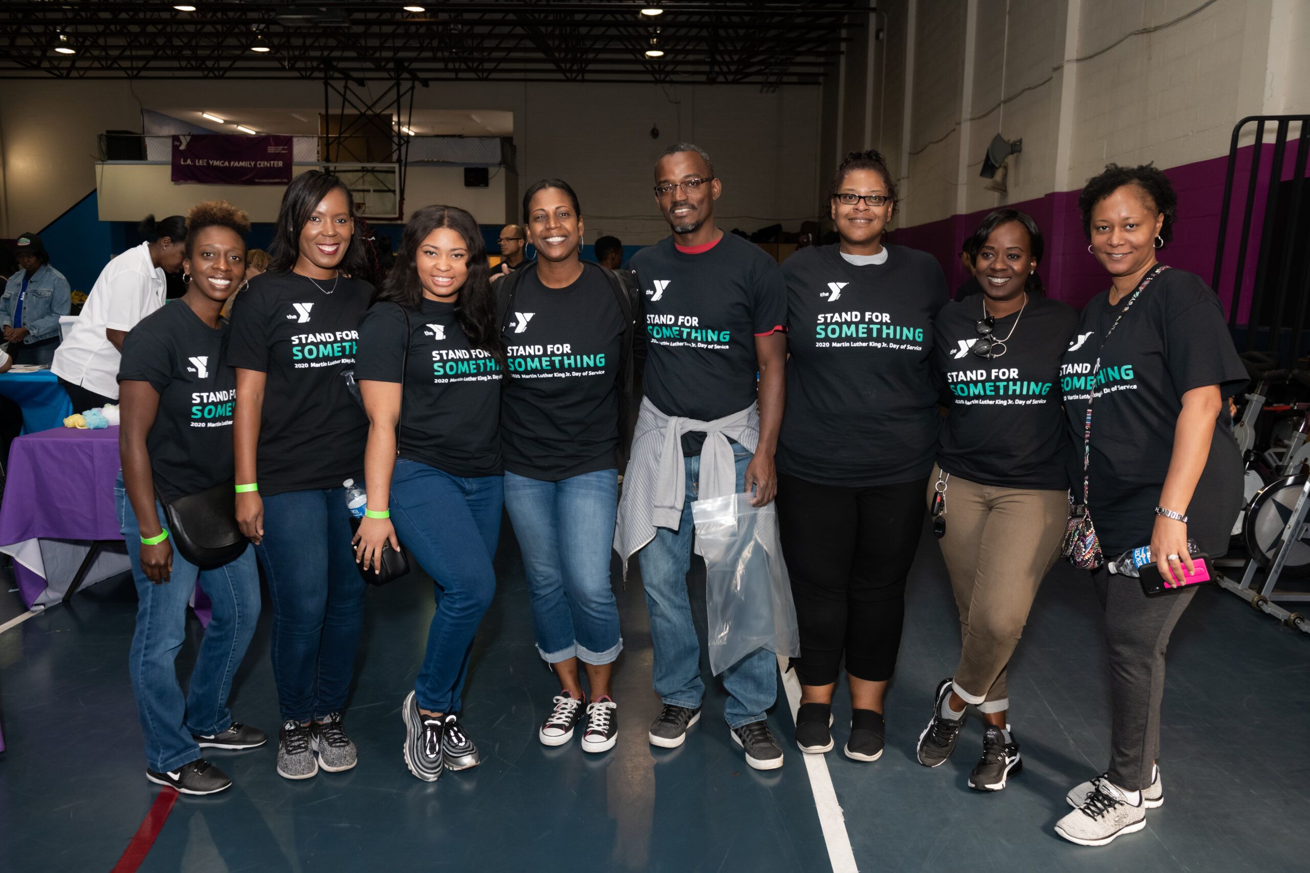 Group of volunteers posing for photo at a community event