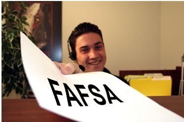 advisor holding paper with fafsa written on it