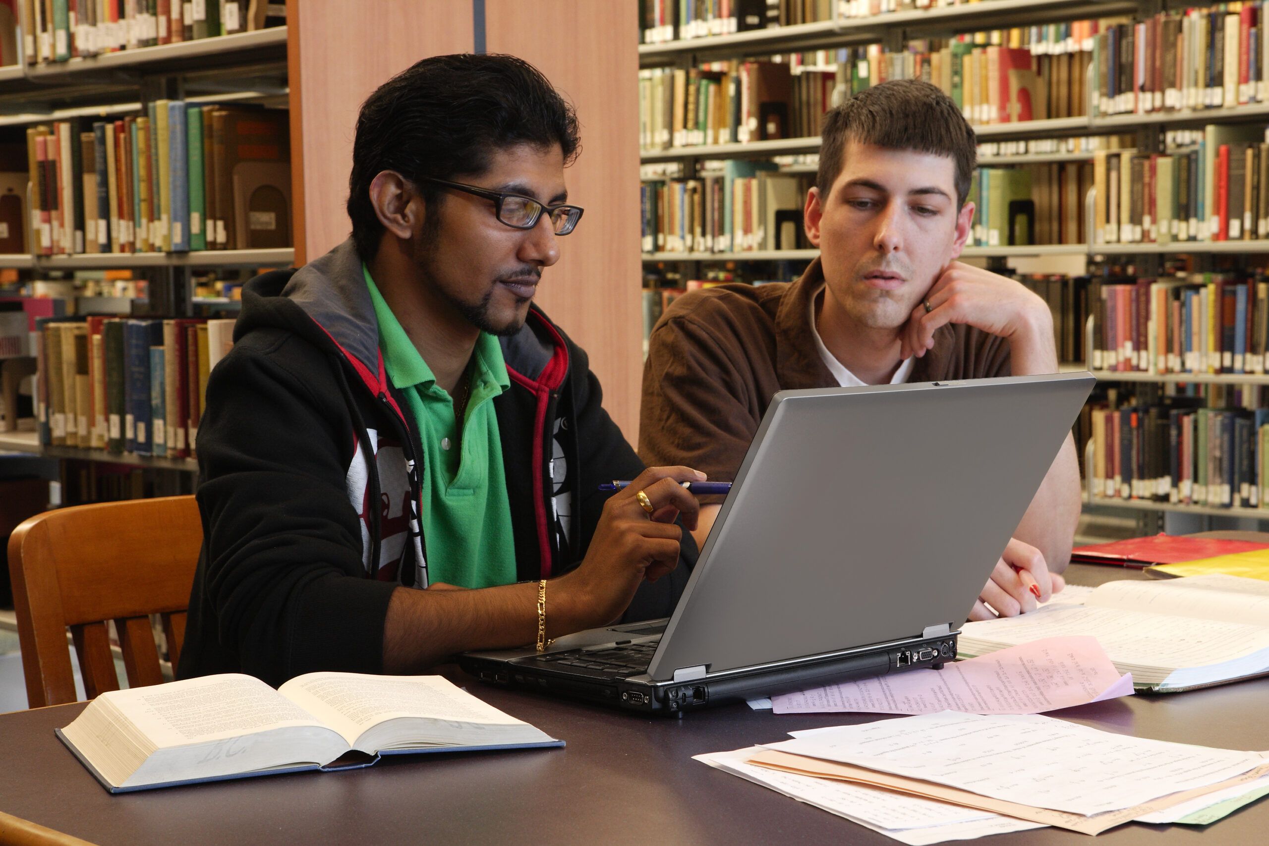 Students study at table in library